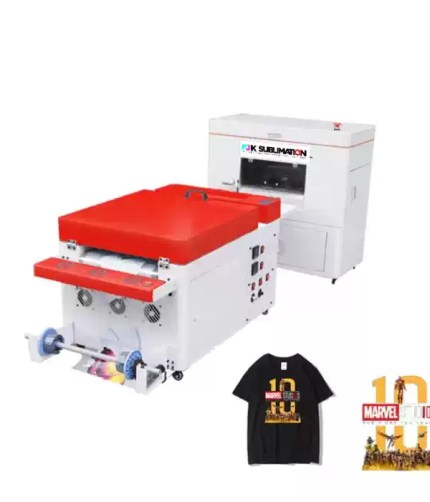 FJK Sublimation industrial printer and curing equipment setup displayed alongside a black t-shirt and graphic sheet featuring Marvel Studios branding.