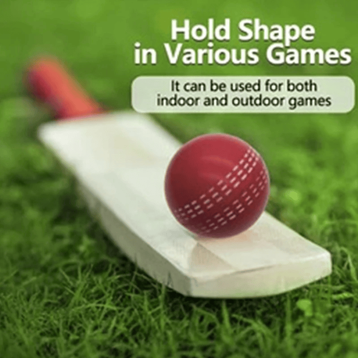 Red soft PU cricket ball resting on a wooden bat over green grass with indoor and outdoor play text.