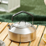 1.5L camping water kettle in a sleek grey finish boiling over a portable outdoor stove.