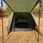 Two hikers resting inside a 210D Oxford tent during a mountaineering trip.