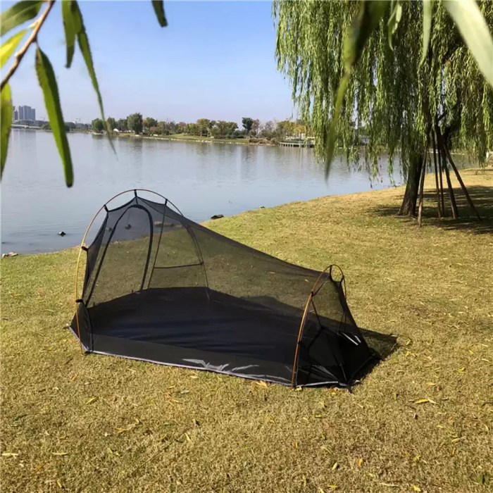 Water-resistant camping tent set up on a sandy beach for a weekend trip.