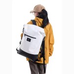 Water splashing against the 27L dry bag to demonstrate its waterproof seal.