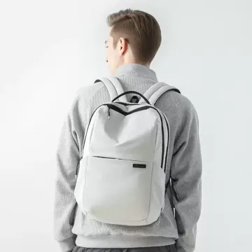 White Backpack Back View Man wearing a white travel backpack with adjustable black shoulder straps