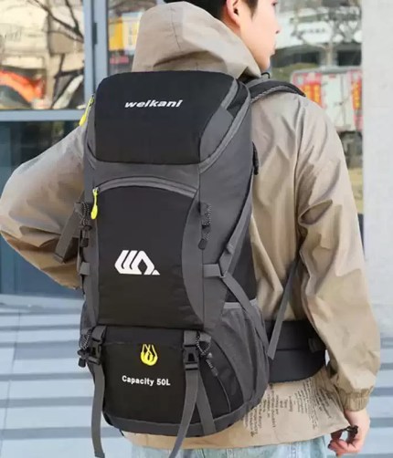 Close-up of the waterproof fabric on the 50L hiking bag with water droplets beading off.