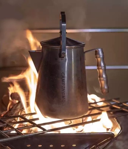 SW-6 stainless steel camping tea kettle over an open campfire.