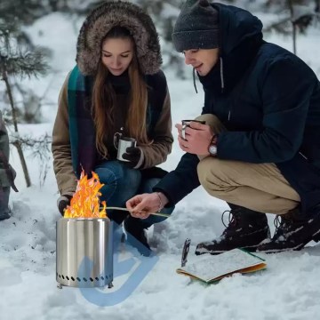 Campers using a portable stainless steel camping stove in snowy conditions, compact outdoor stove for winter camping and outdoor cooking.