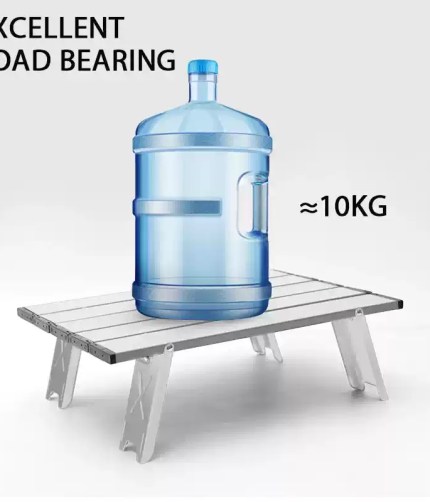 Close-up of the shock-corded frame legs being assembled for a portable outdoor table.