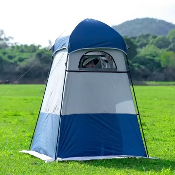 Tall camper standing inside the 240cm shower tent to show headroom.