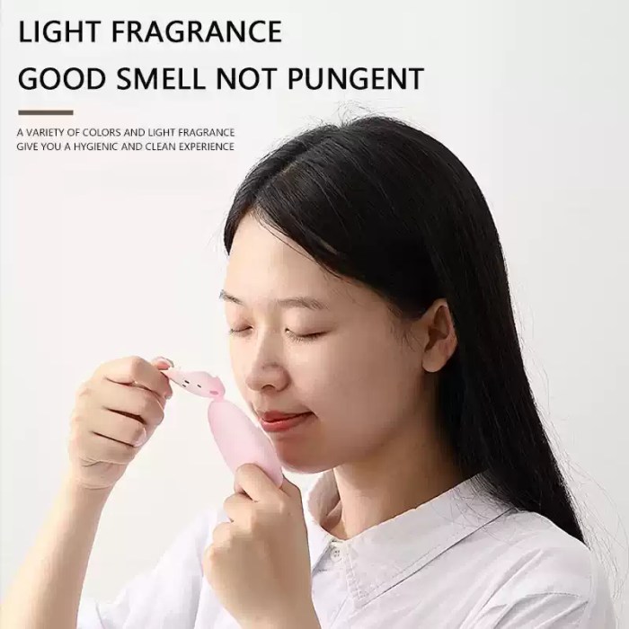 Portable soap paper case held between two fingers to show its ultra-compact size for travel.