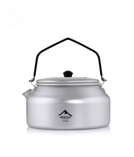 1L aluminum camping kettle in dark grey shown boiling water on a portable gas stove.