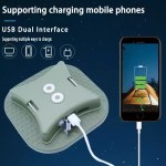 A green multi-functional camping light connected via a USB dual interface to charge a mobile phone, showing a battery charging icon on screen.