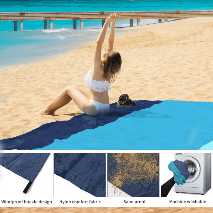 2x2.1m Waterproof Pocket Beach Blanket (5) Corner loops of a beach mat being staked into the ground near a 2 person tent.