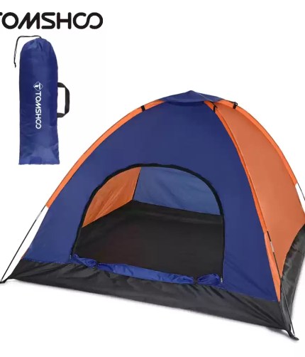 3-4 person camping tent set up in a green forest clearing.
