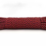 The 328ft lanyard rope coiled neatly next to a survival kit and camping cup.