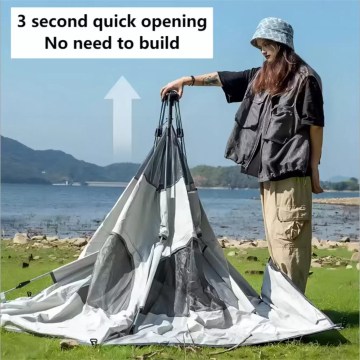 Portable pop up tent springing into shape instantly at a campsite.