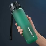 FJK Camping Gear water bottle shaker filled with fresh water on a trail.