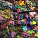 5m paracord coil being used to create a survival bracelet for climbing.