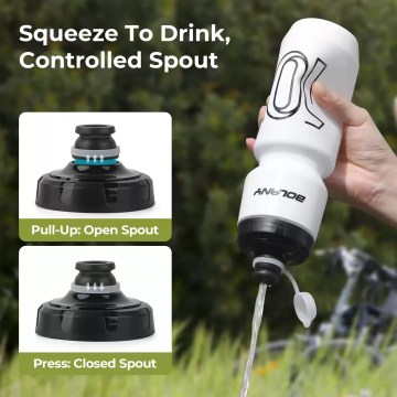 A hand squeezing the ultralight sports bottle for a quick drink while cycling.