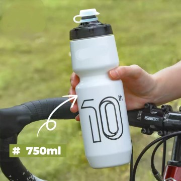A 750ML sports bottle mounted on a mountain bike frame during a nature hike.