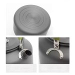 Heat-resistant insulated handle on a portable camping kettle for safe pouring on wilderness expeditions.