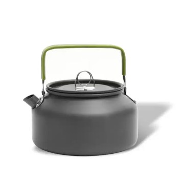 An aluminum camping kettle sitting on a picnic table next to a fishing rod and tackle box.