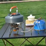 0.8L lightweight portable kettle being placed inside a camping rucksack for a backpacking trip.