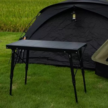 Extensible picnic table with camping mugs and a portable stove placed on the heat-resistant surface.