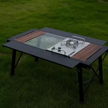 Detachable roll-top camping table being assembled quickly by a hiker next to a tent.