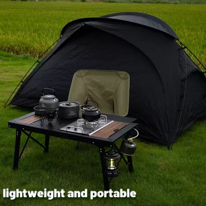 Aluminum Alloy Lifting Table_6 Black aluminum alloy table with adjustable lifting legs shown in a woodland camping setup.