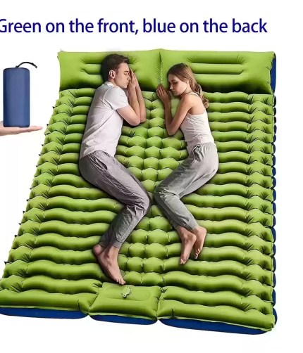 Couple sleeping on double green inflatable camping mattress with pillows