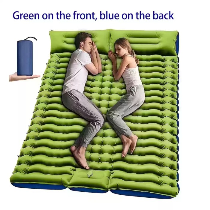 Couple sleeping on double green inflatable camping mattress with pillows