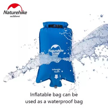 Alt Text: Compact couple backpacking sleeping mat deflated and stored in a small waterproof compression sack held in one hand.