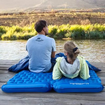 Alt Text: Top-down view of a camping sleeping pad with pillow featuring a blue honeycomb air-cell structure for back support.