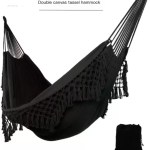 A couple relaxing in the enlarged double hammock inside a cozy sunroom.