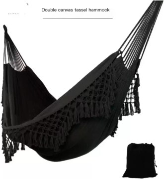 A couple relaxing in the enlarged double hammock inside a cozy sunroom.