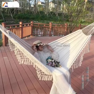 Close-up of the hand-woven retro tassels on the blue outdoor hanging chair.