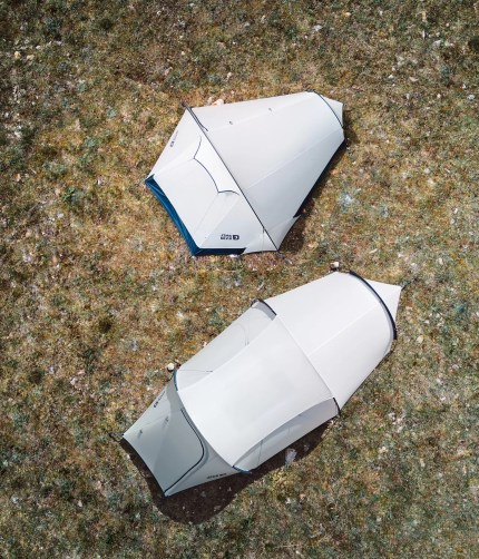 Waterproof double layer trekking tent showing the rain fly shedding water during outdoor camping.