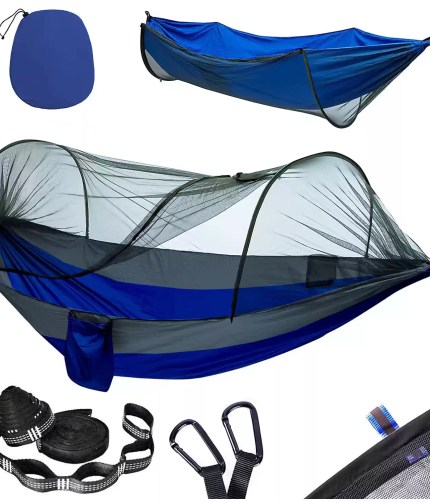 Double camping hammock with mosquito netting popped open between two trees.