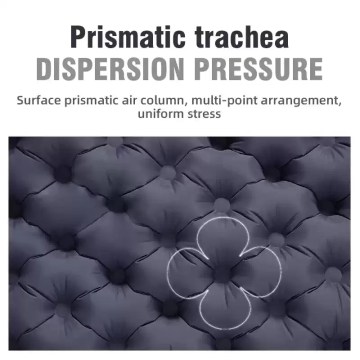 Blue ultralight folding bed sleeping mat fully inflated on a forest floor next to a camping tent.