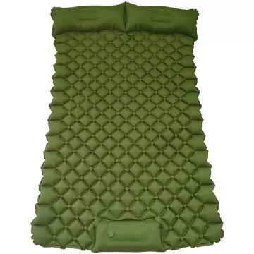 Double sleeping pad for camping fully inflated inside a spacious green tent.