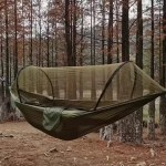 Outdoor camping hammock with mosquito net showing the fine mesh enclosure in a forest.