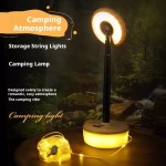 Telescopic camping lamp standing beside warm yellow fairy string lights.