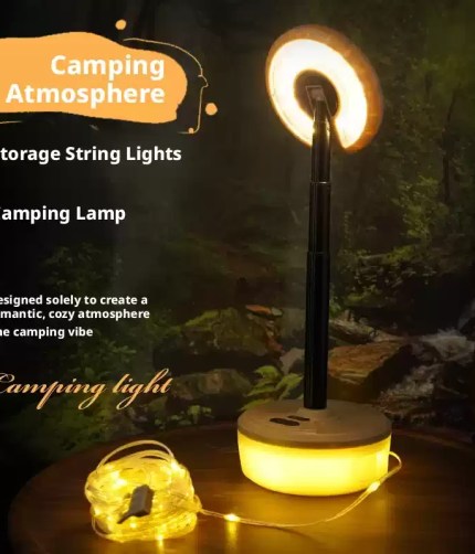 Telescopic camping lamp standing beside warm yellow fairy string lights.
