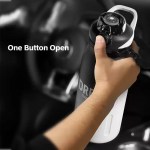 One hand open outdoor portable thermos bottle used on a nature hike.