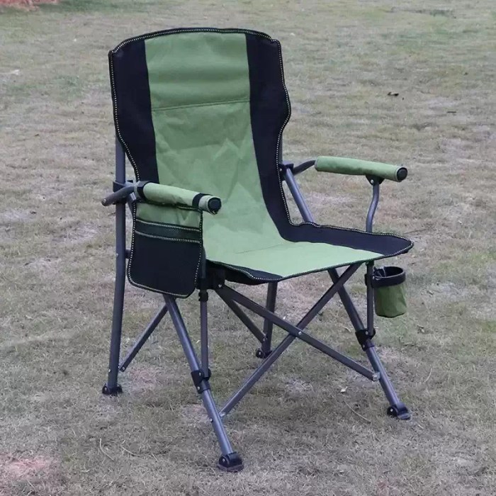 OUTDOOR LARGE FISHING CHAIR_2 A person folding the high back chair into its black carry bag for transport.