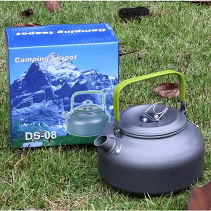 Pouring hot water from a DS08 alloy coffee pot into a camping mug during a nature hike.