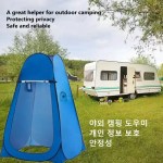 The outdoor portable camping shower tent folded flat inside its round black carry bag.