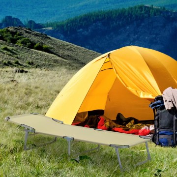 Camping cot bed near tent for outdoor hiking and travel