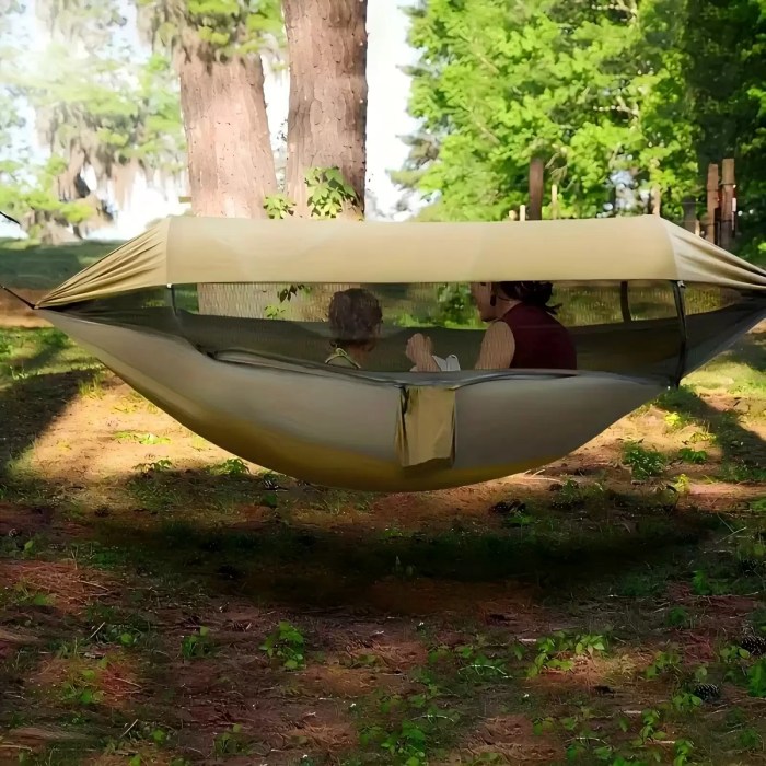 Portable camping hammock with mosquito net and green awning.