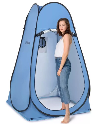 Blue pop up privacy shelter on a beach.